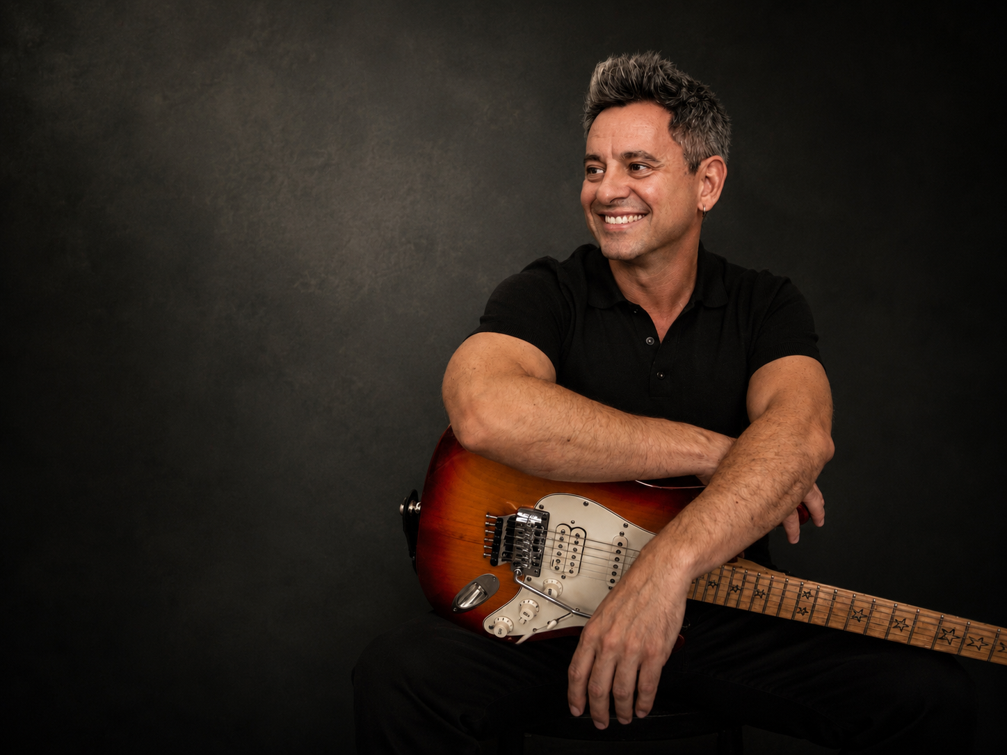 Editorial portrait of Miquel Porcel with an electric guitar.